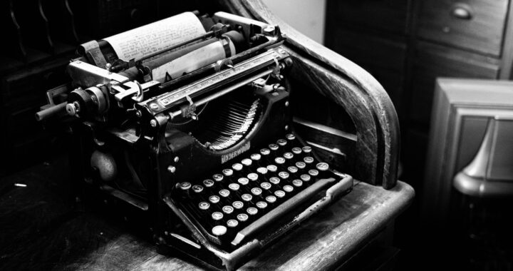 black and gray typewriter on table